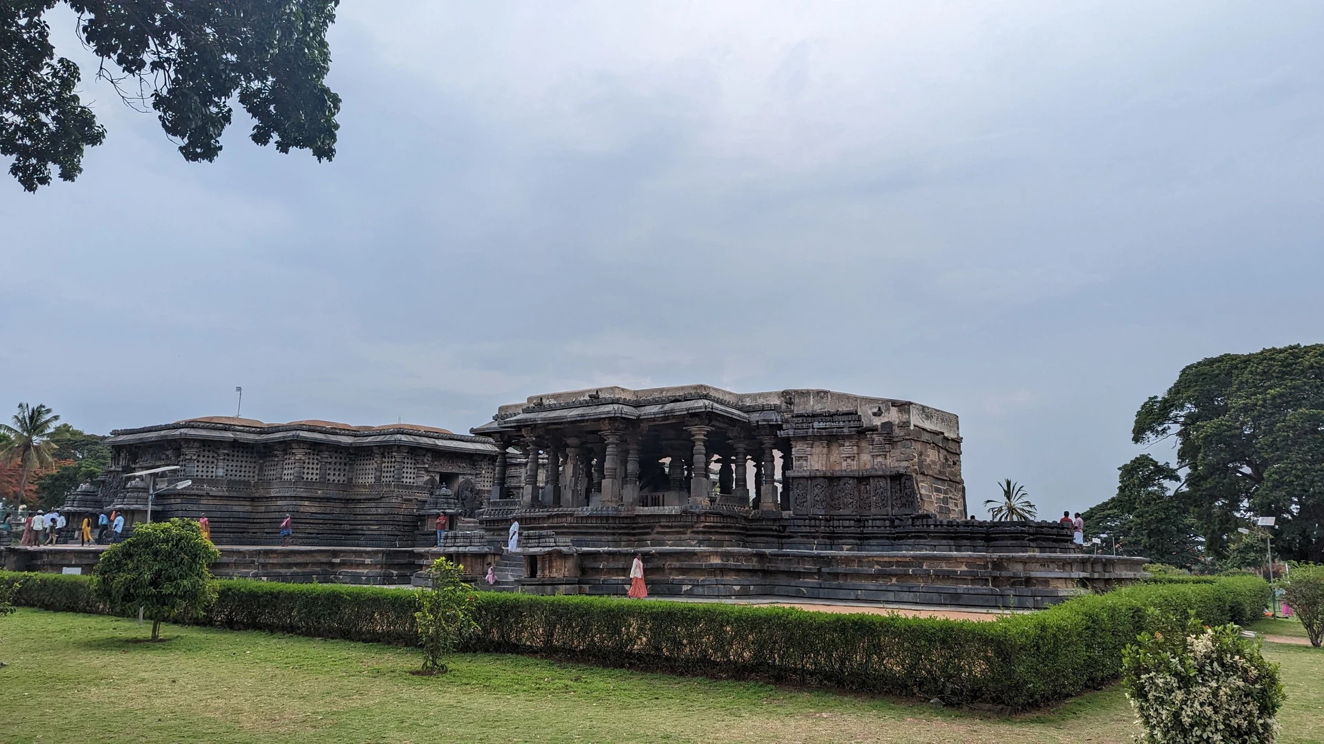Narrative panel on Hoysaleswara Temple outer wall — figures read left to right like a stone manuscript