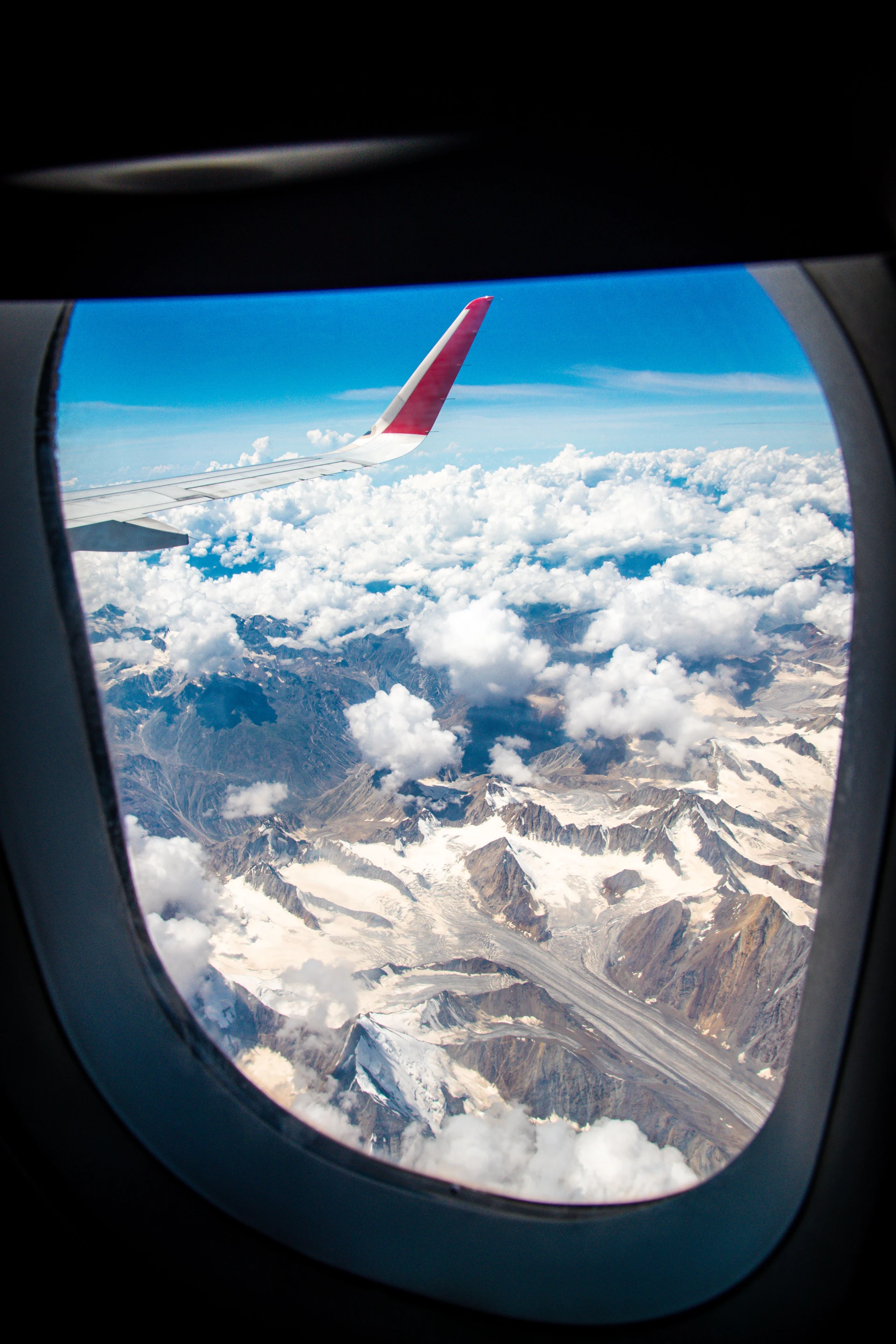 Himalayan peaks from airplane window, approach to Leh