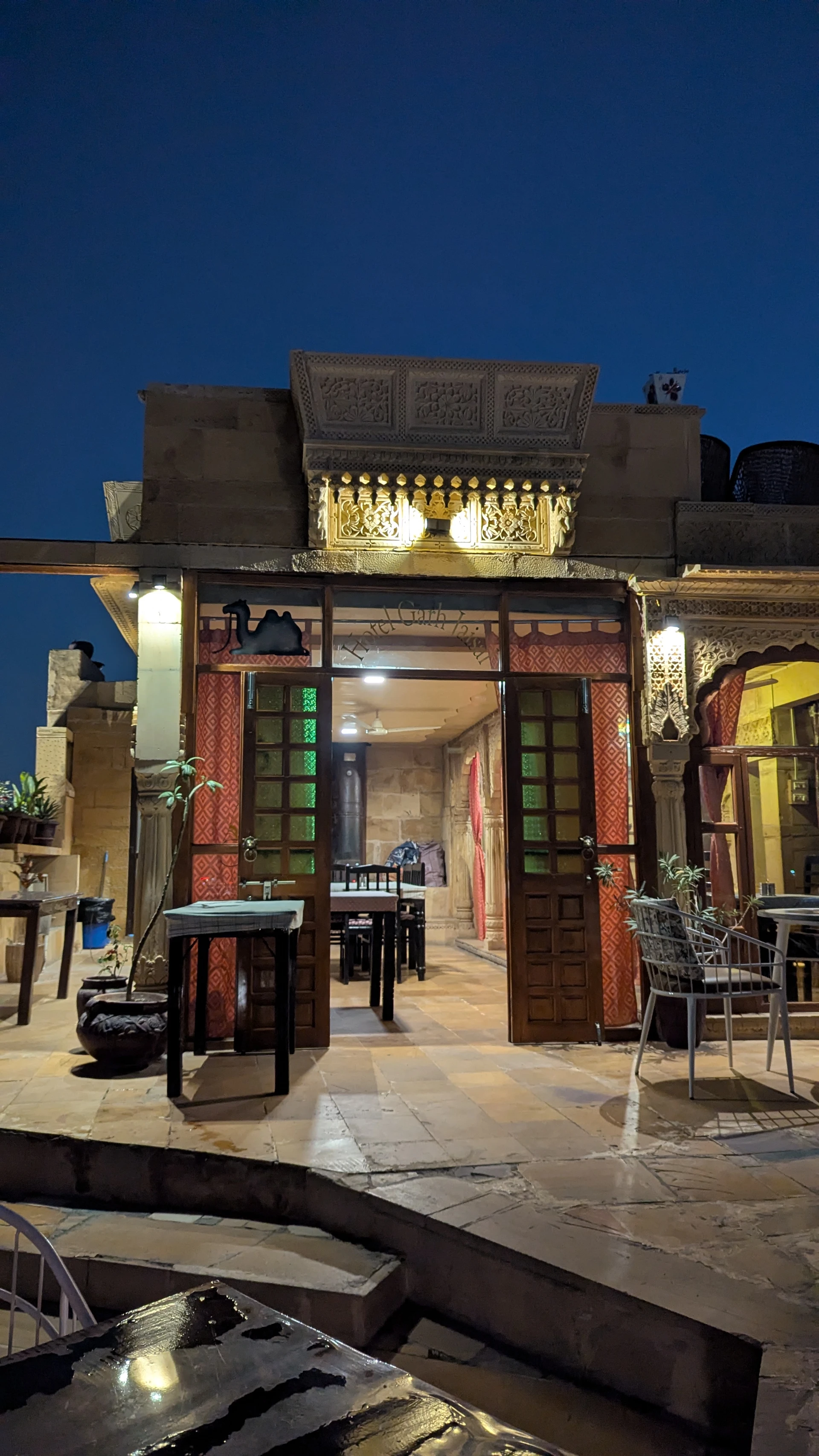 Jaisalmer Fort by night outside Garh Jaisal Haveli, warm street lamps turning the sandstone amber