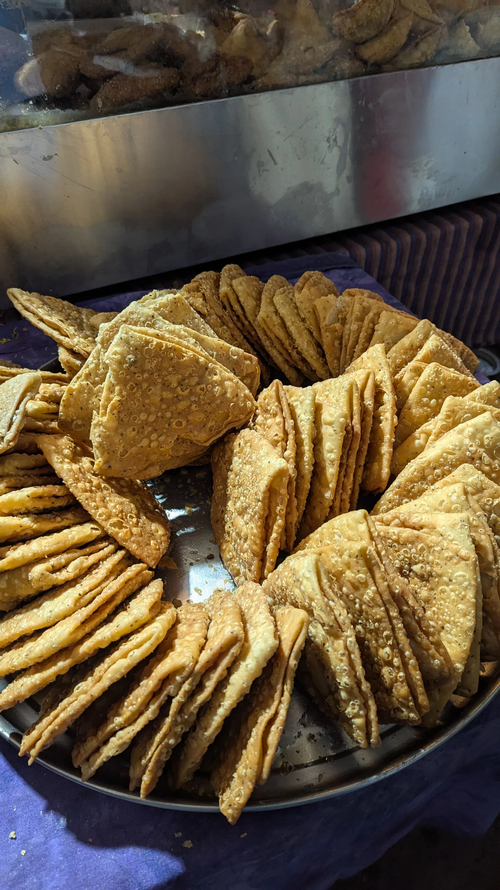 Deep-fried street food snacks in Jodhpur, flaky mathris and local pastries
