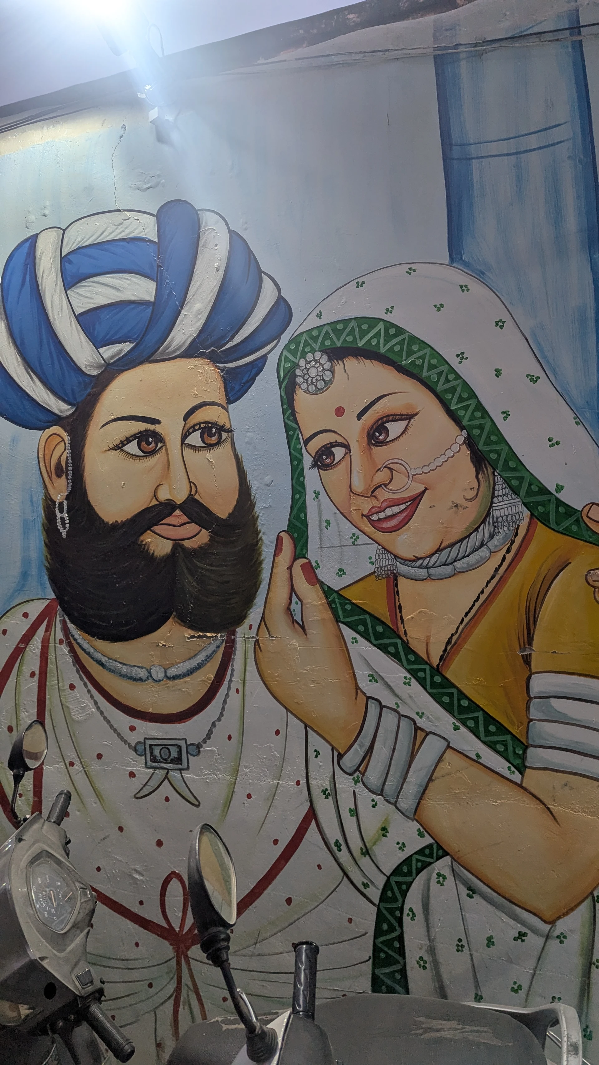 Street art mural in Jodhpur depicting traditional Rajasthani turban and jewelry