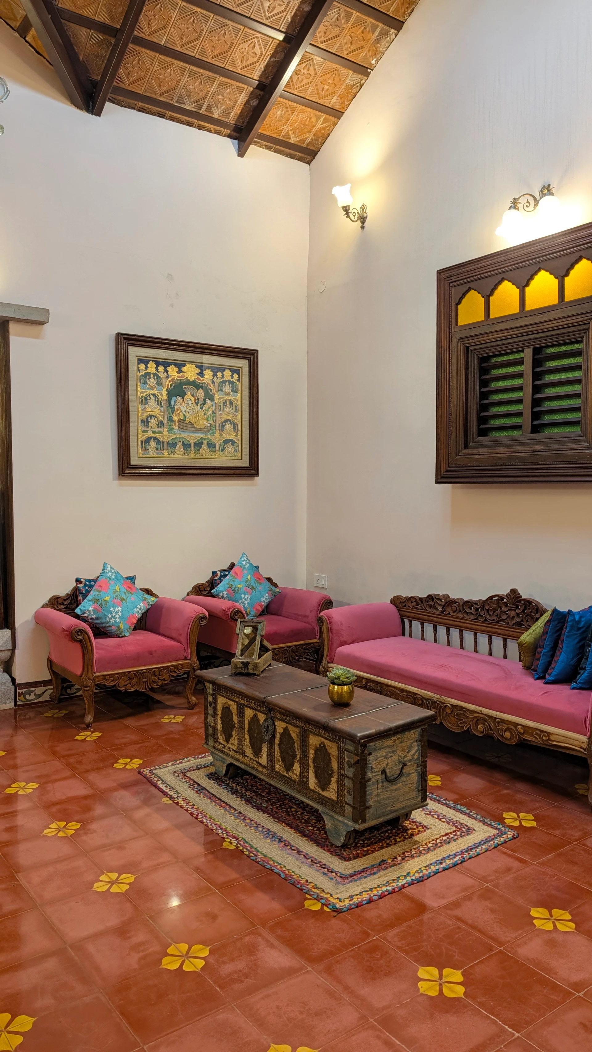 Seating area at Woodway Estate with carved woodwork and colourful cushions